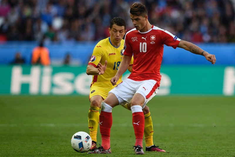 El suizo, Xhaka, y el rumano Prepelita disputando el balón. Foto: AFP