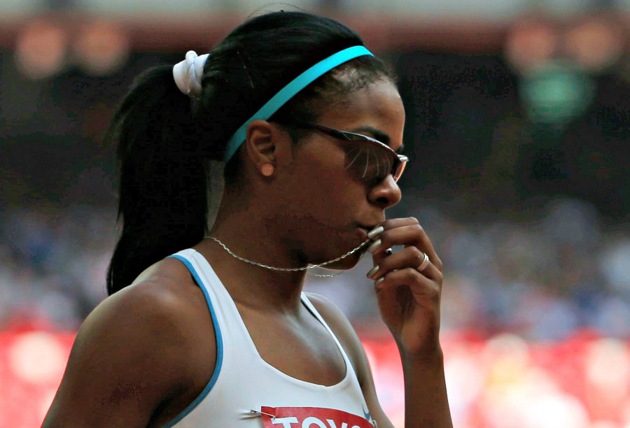 Déborah Rodríguez besando su cruz antes de correr. Foto: Reuters