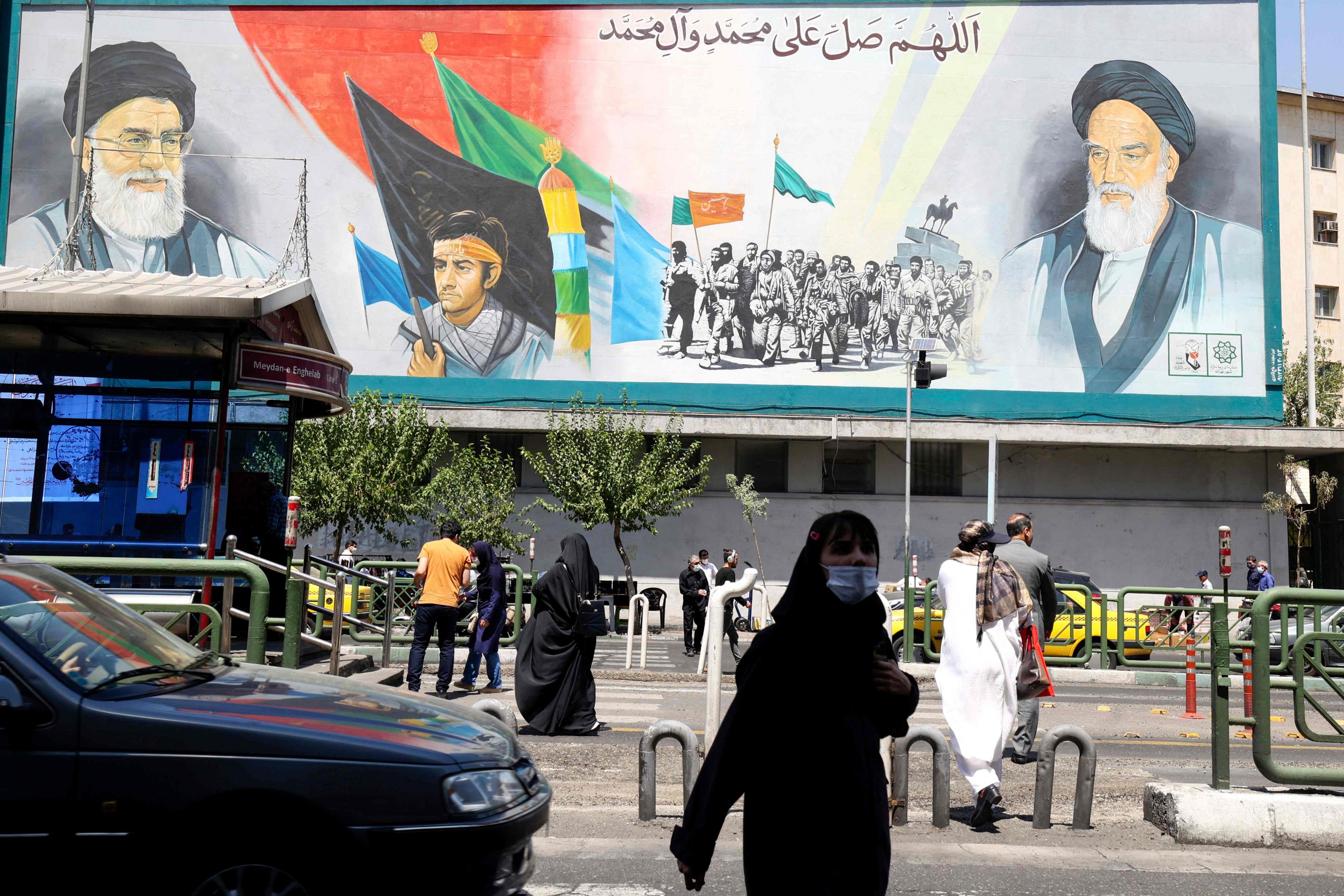 Iraníes pasan frente a una valla publicitaria con los retratos del líder supremo de Irán, el ayatolá Ali Khamenei, y el difunto líder supremo, el ayatolá Ruhollah Khomeini, en Teherán. Foto: AFP