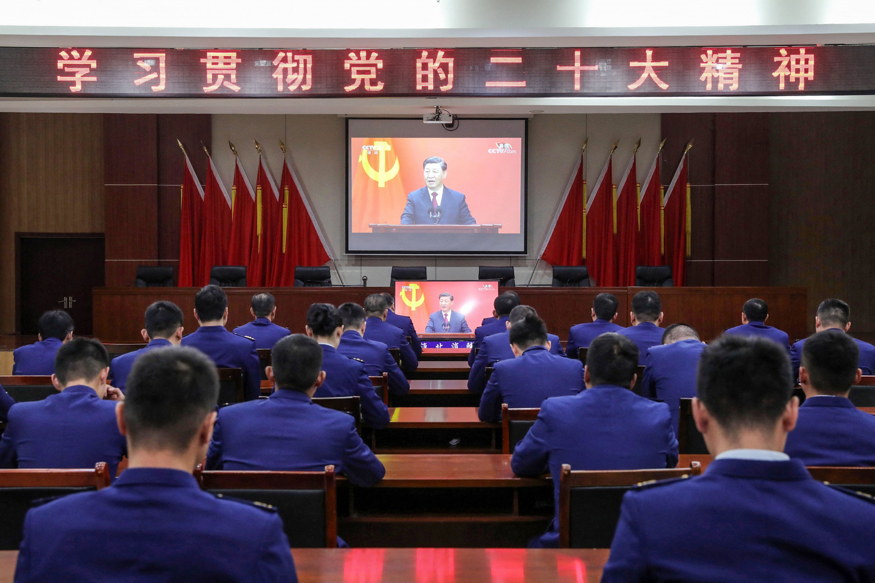 La gente ve en vivo el discurso del presidente de China, Xi Jinping, durante la presentación del Comité Permanente del Politburó del Partido Comunista. Foto: AFP.